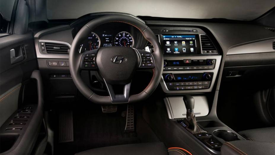 Seu interior é um pouco simples, mas vem muito bem equipado com ar condicionado e assentos de estofado premium | <a href="https://beta-develop.quatrorodas.abril.com.br/noticias/saloes/new-york-2014/hyundai-revela-sonata-2015-nova-york-779988.shtml" rel="migration">Leia mais</a>