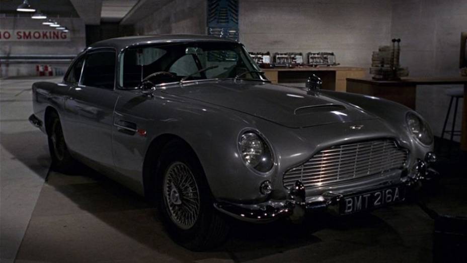 1964: O mais famoso veículo utilizado pelo espião estreia em "007 contra Goldfinger": o Aston Martin DB5. | <a href="%20https://beta-develop.quatrorodas.abril.com.br/blogs/planeta-carro/2012/11/07/licenca-para-acelerar/" rel="migration">Leia mais</a>