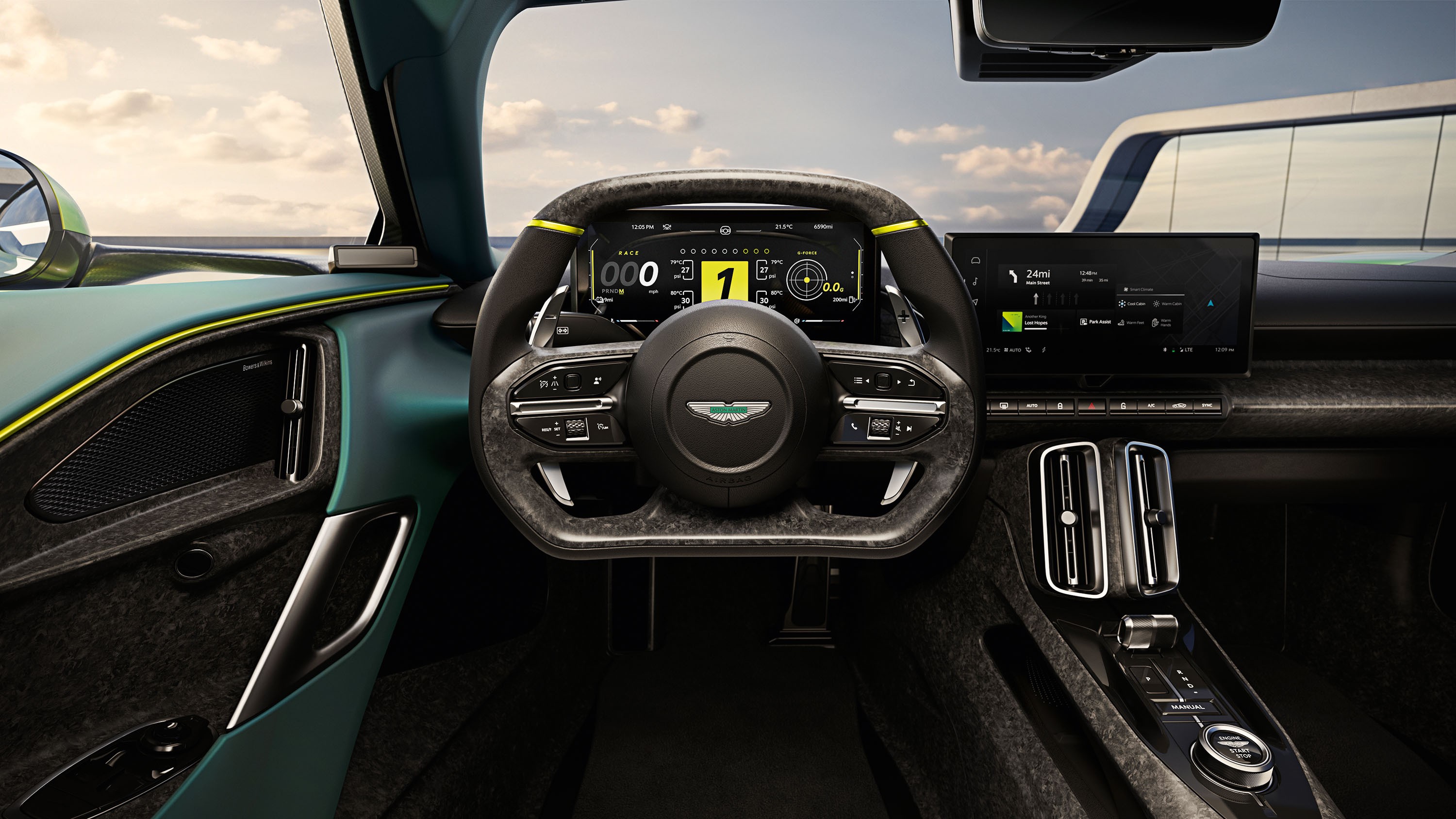 Interior de um carro esportivo Aston Martin, com volante de fibra de carbono e detalhes em verde-lim&atilde;o. O painel digital exibe o n&uacute;mero 1 em destaque, e uma tela multim&iacute;dia &agrave; direita mostra um mapa de navega&ccedil;&atilde;o. O acabamento interno &eacute; em tons escuros, com detalhes em verde-azulado nas portas e costuras amarelas. O c&eacute;u nublado &eacute; vis&iacute;vel pelas janelas