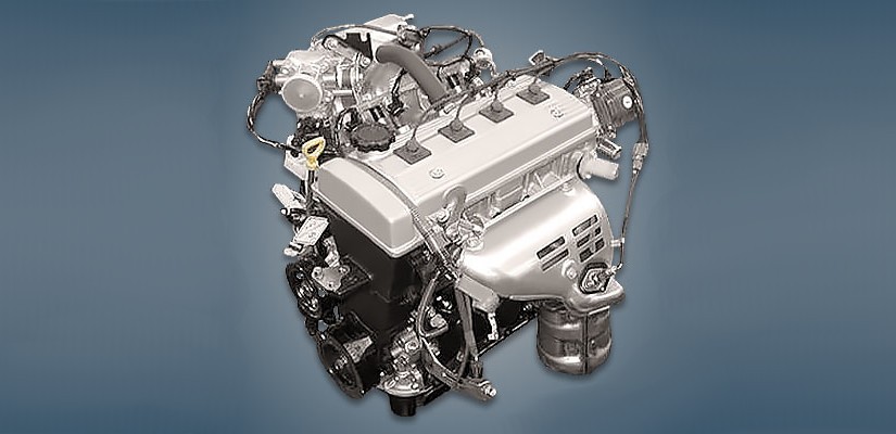 Motor de carro prateado e preto, com v&aacute;rias mangueiras e fios conectados, visto de cima em um fundo azul escuro