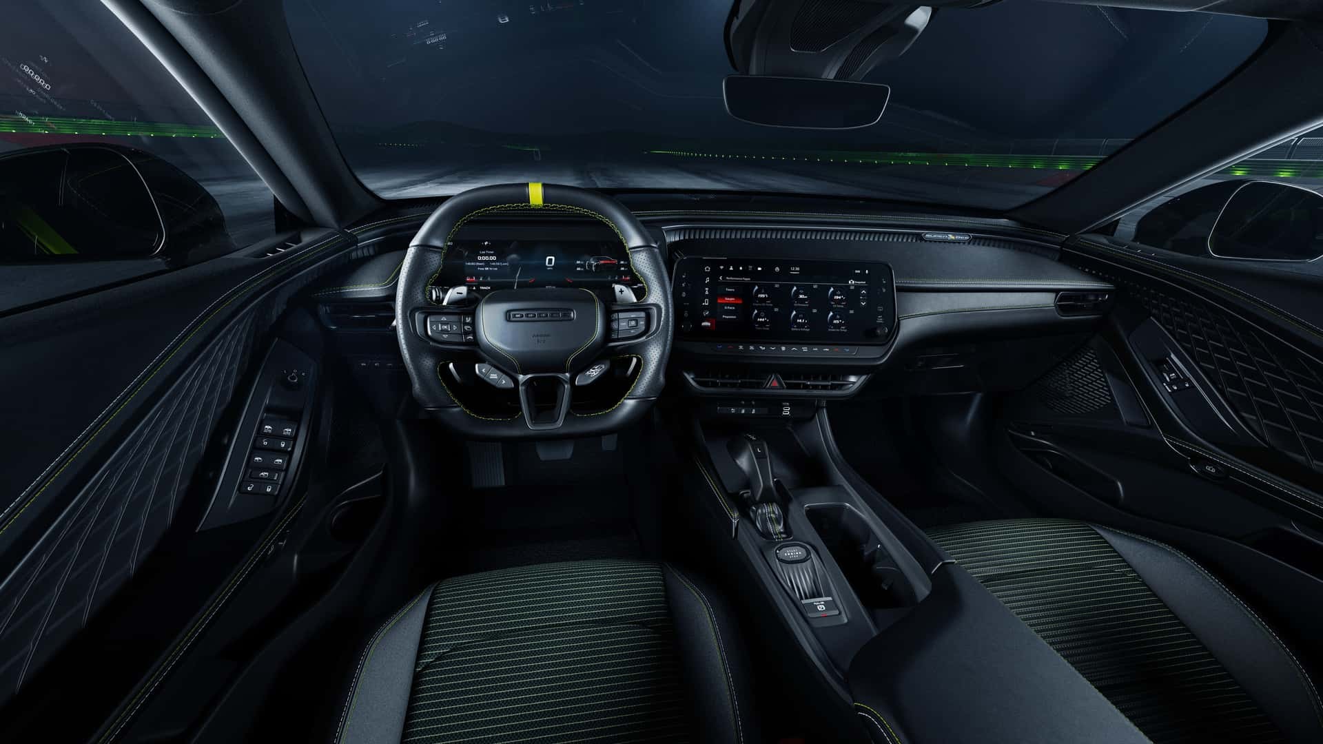 Interior de um carro esportivo moderno, com volante escuro e faixa amarela no topo, painel digital e tela multim&iacute;dia. Os bancos s&atilde;o pretos com detalhes em verde escuro, e o ambiente &eacute; iluminado por luzes internas e externas, sugerindo movimento noturno